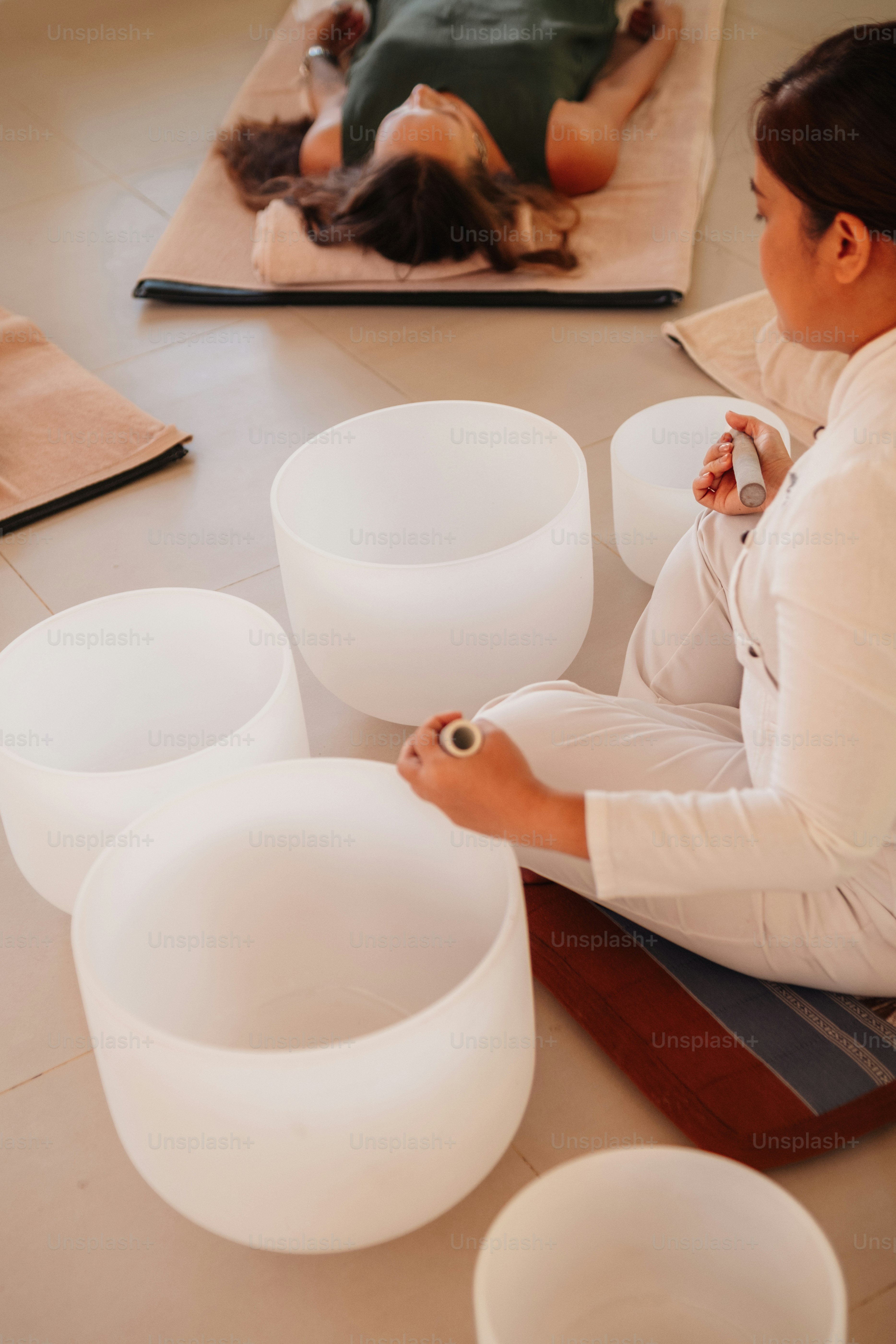 a woman sitting on the floor working on a project