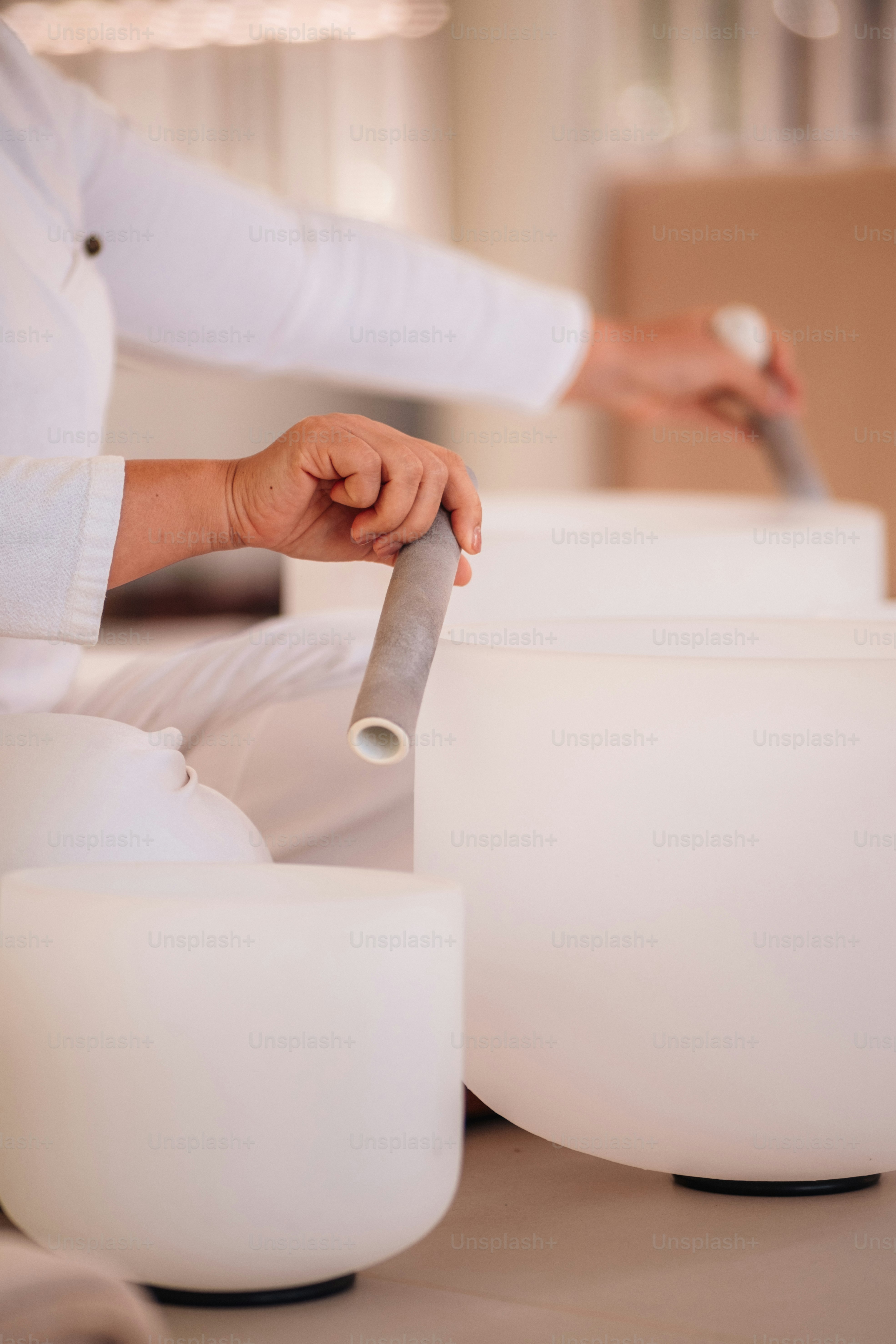 a woman sitting on the floor with a roll of paper in her hand
