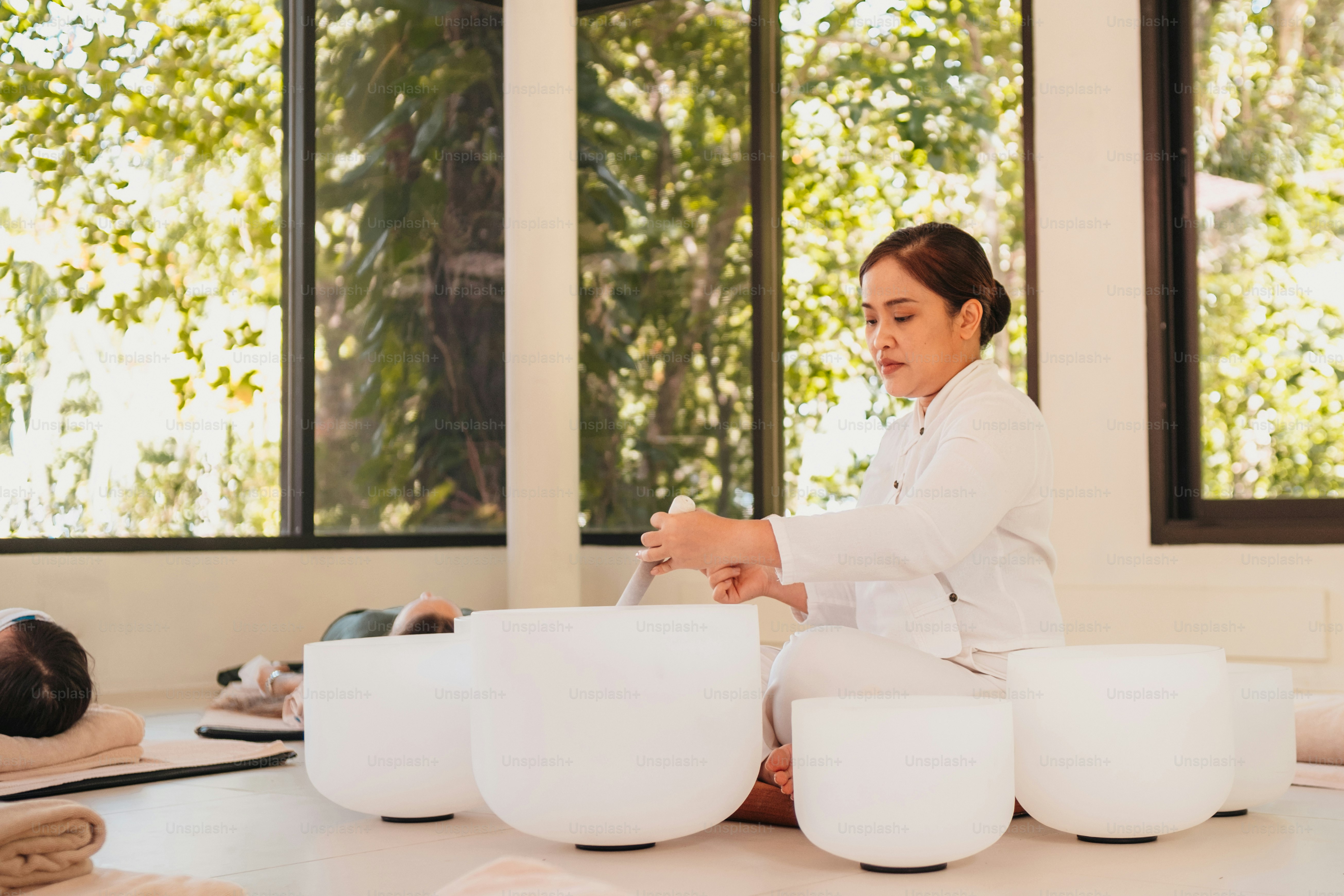 a woman in a white lab coat sitting on a table