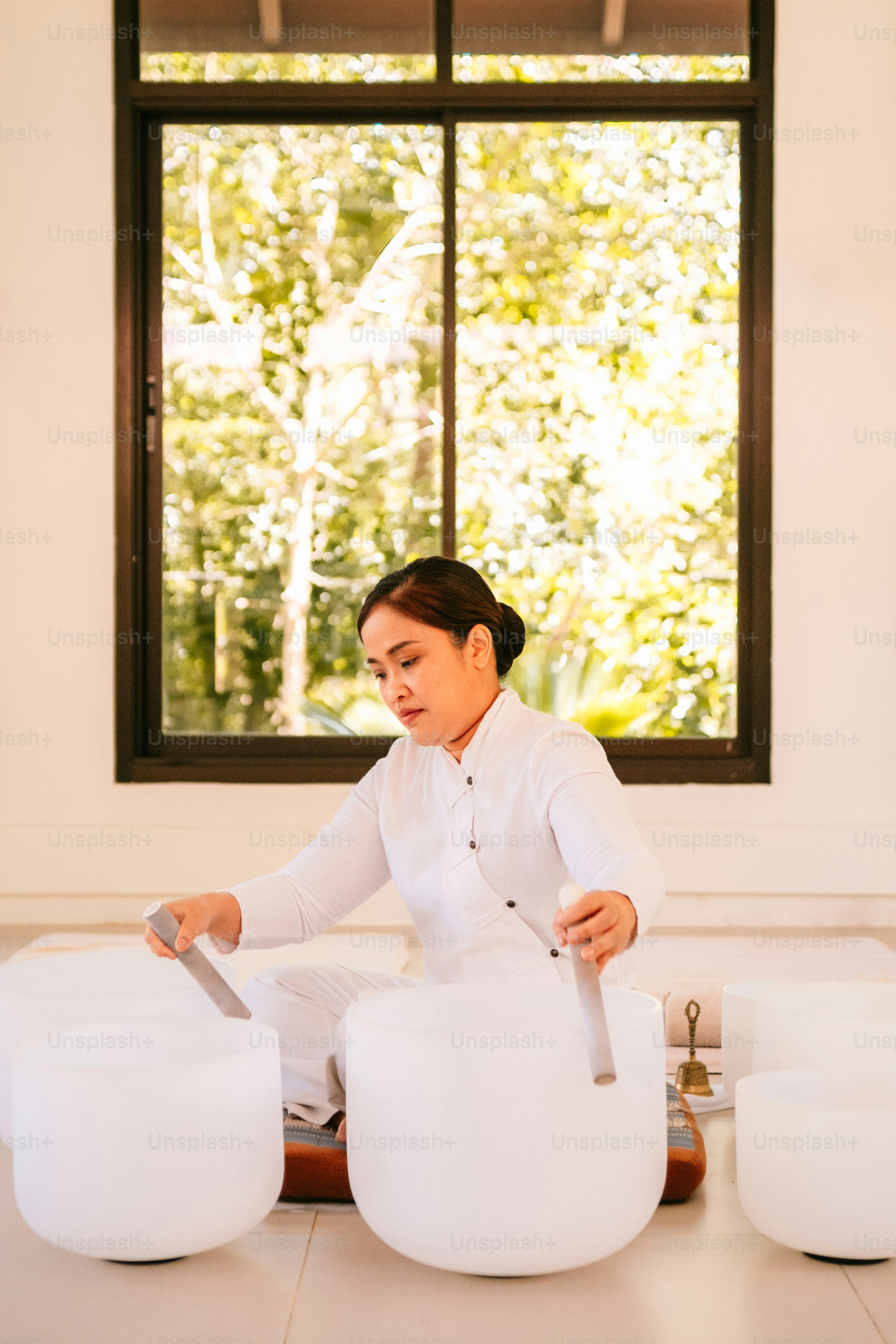 a woman in a chef's uniform cutting a cake with a knife