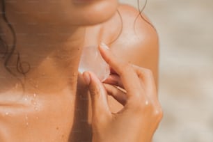 a woman holding a piece of soap in her hand