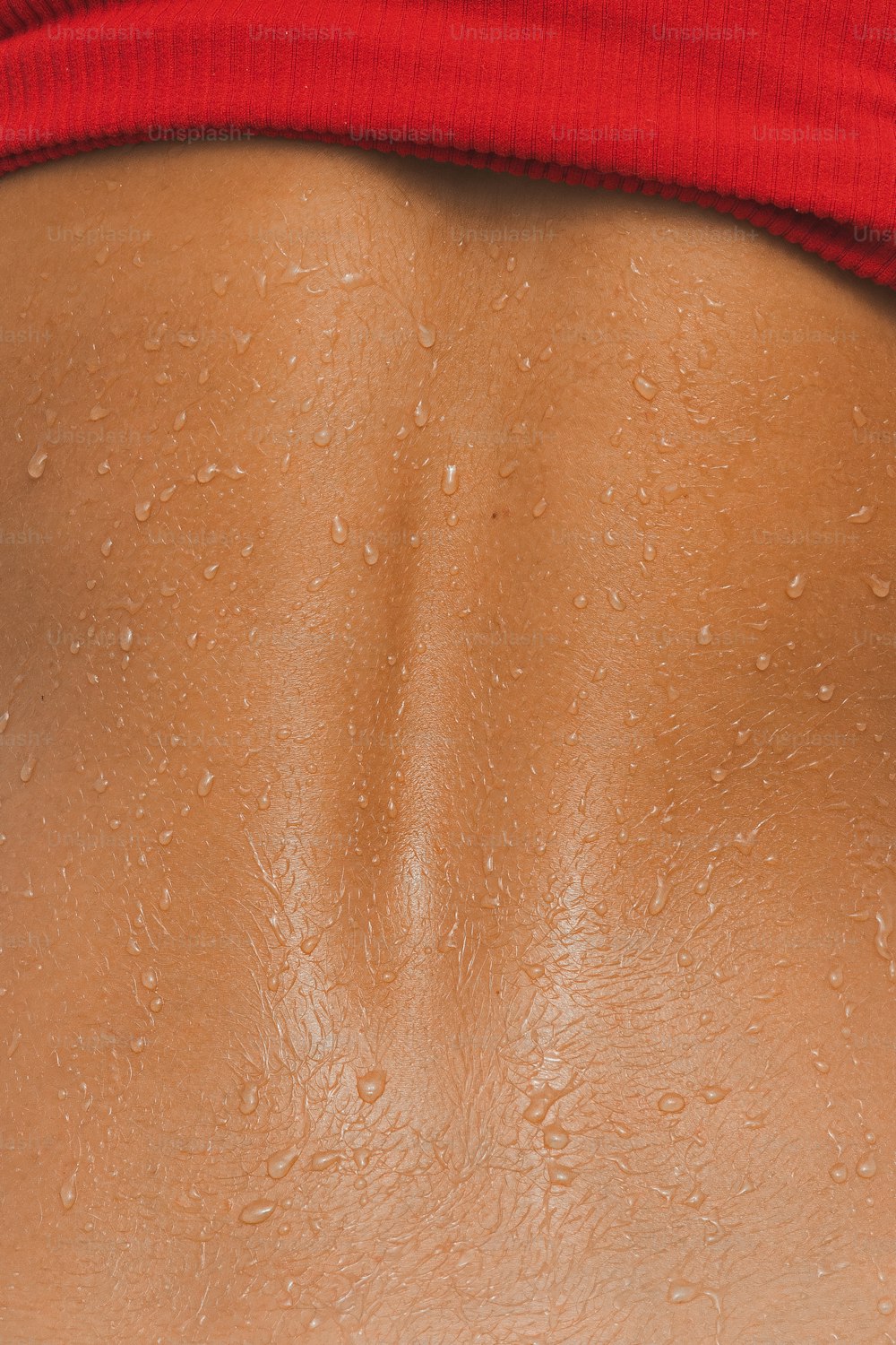 a woman's back with water drops on it