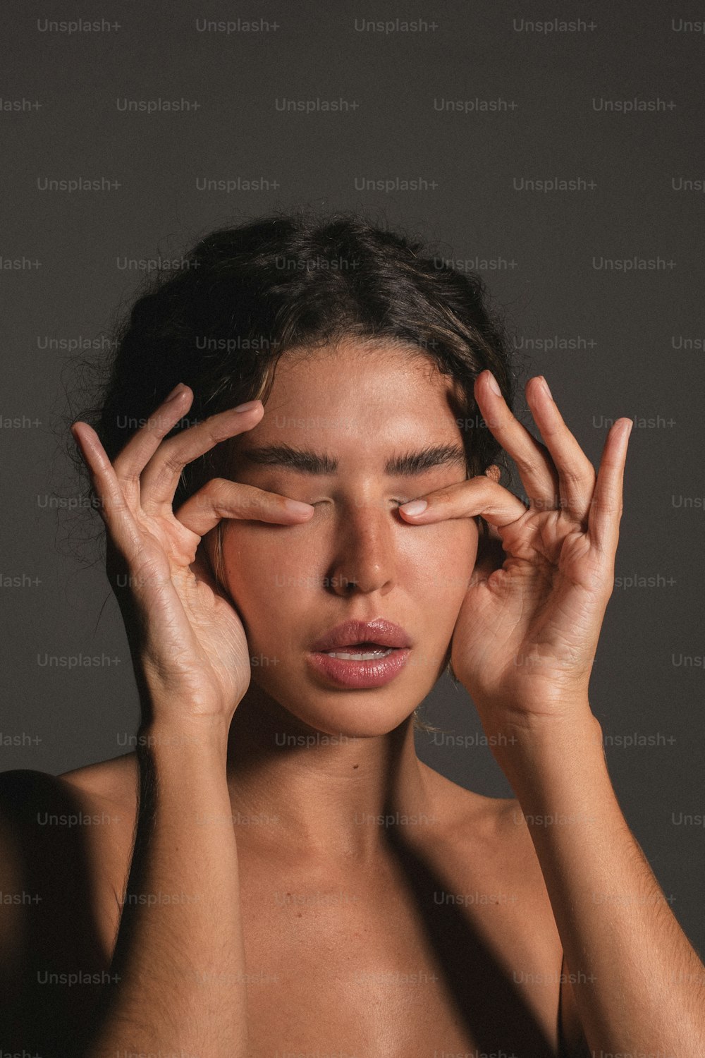 a woman holding her hands to her face