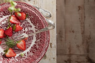 a red and white plate topped with strawberries