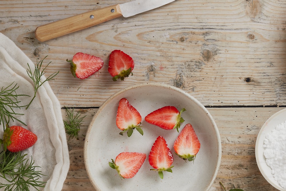 a bowl of strawberries on a white plate