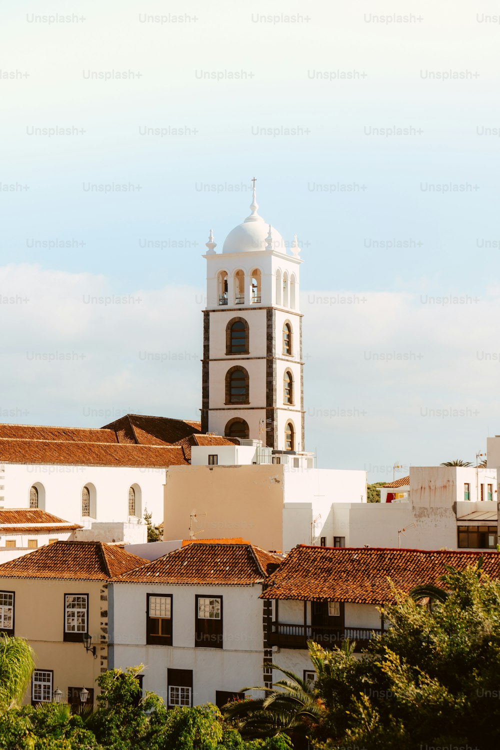 a tall white building with a clock on it's side