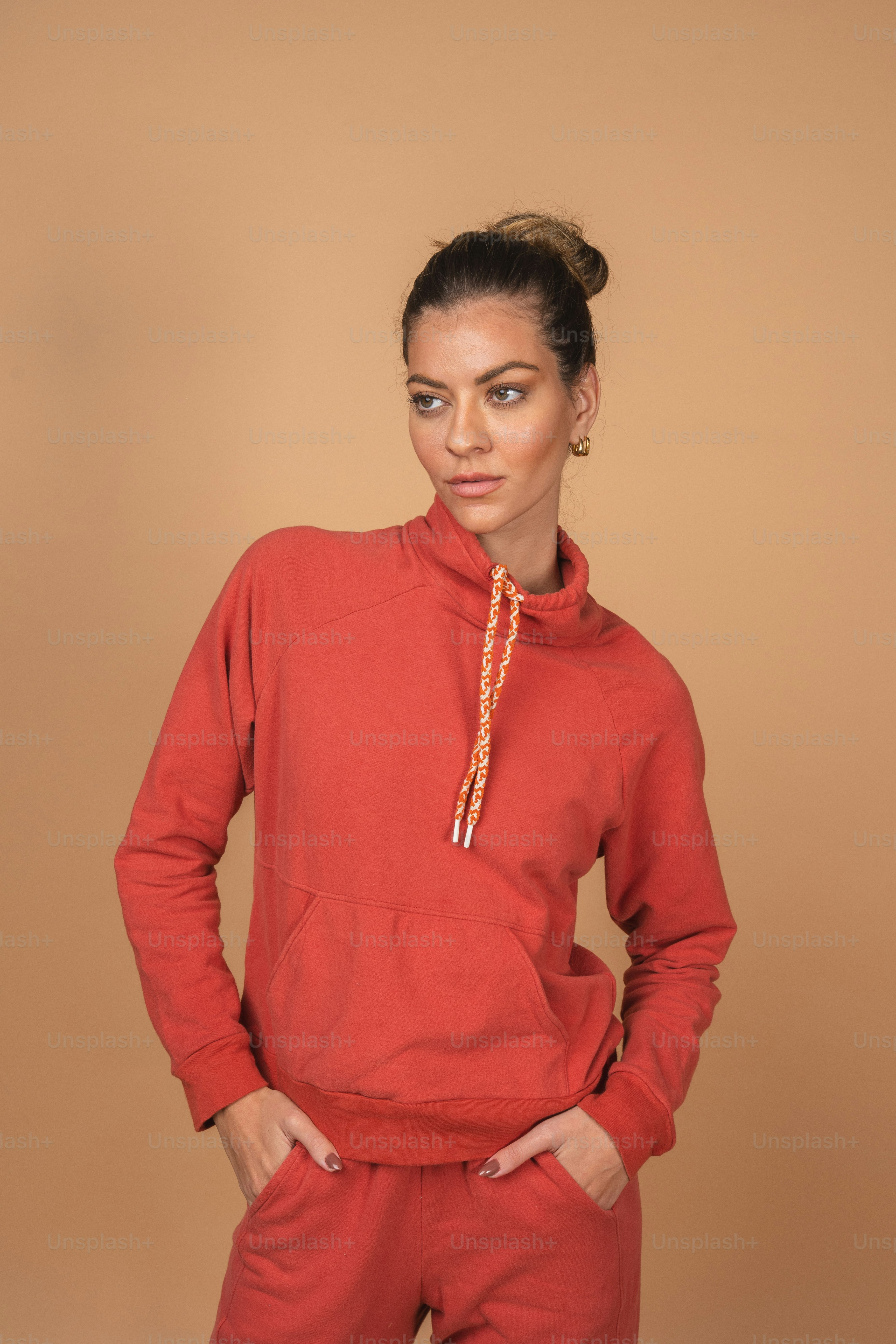 a woman wearing a red sweatshirt and pants