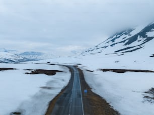 a car driving down a snow covered road