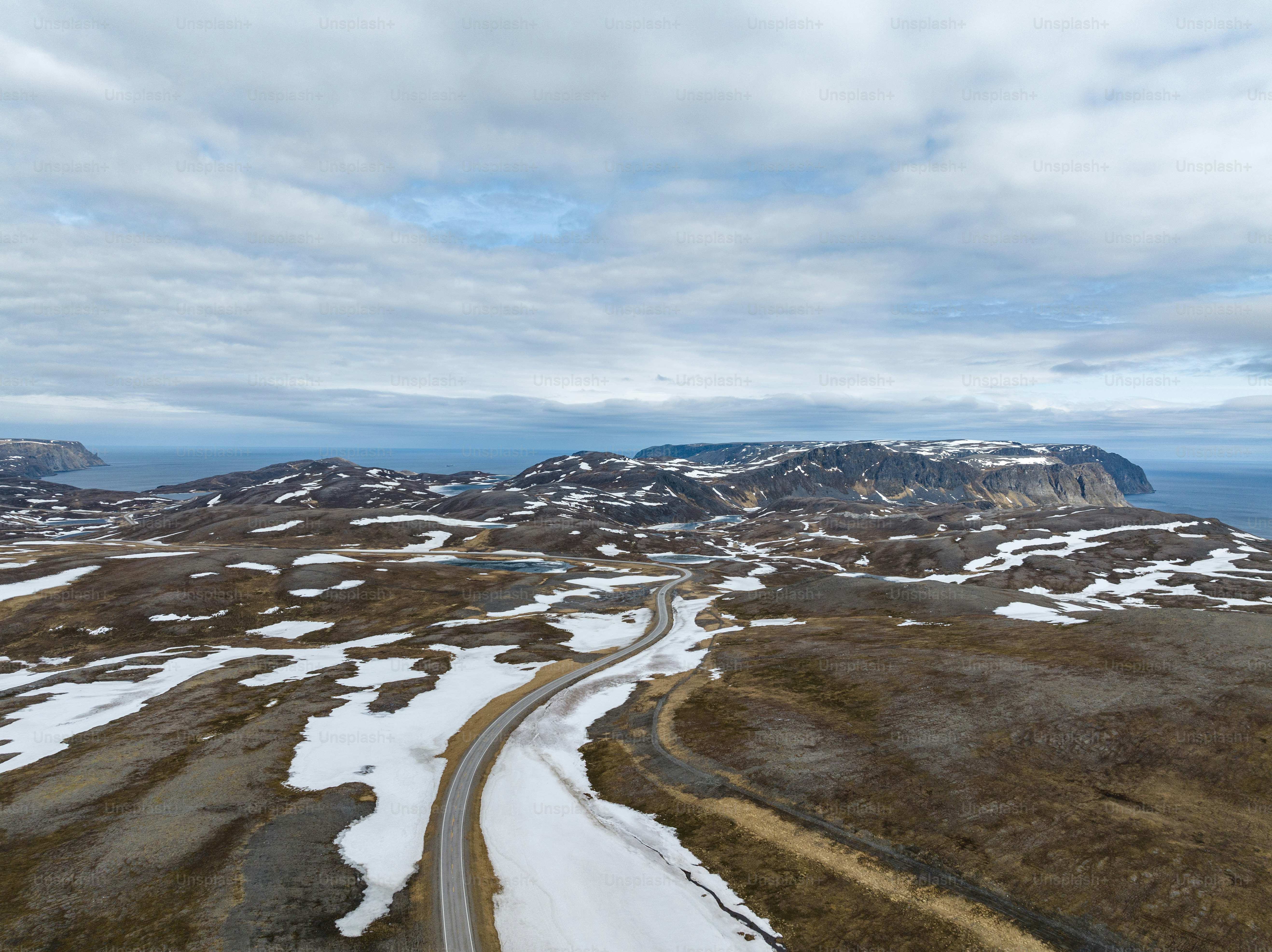 An aerial view of a winding road in the mountains photo – Norway Image ...