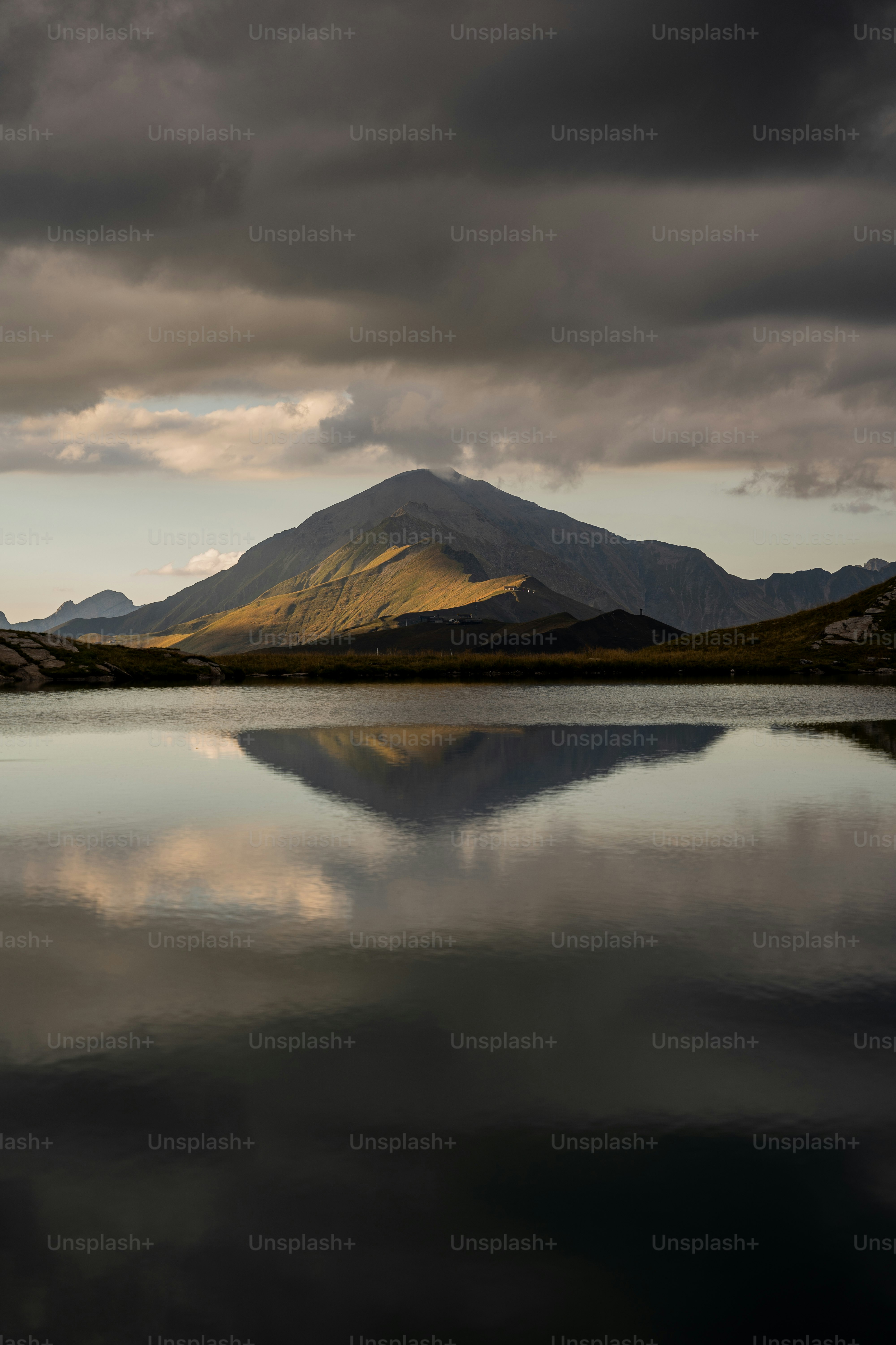 a large body of water with a mountain in the background