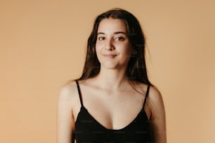 a woman in a black dress posing for a picture