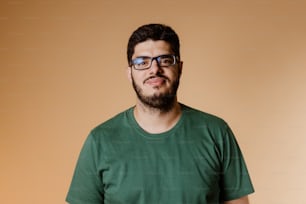 a man with a beard and glasses posing for a picture