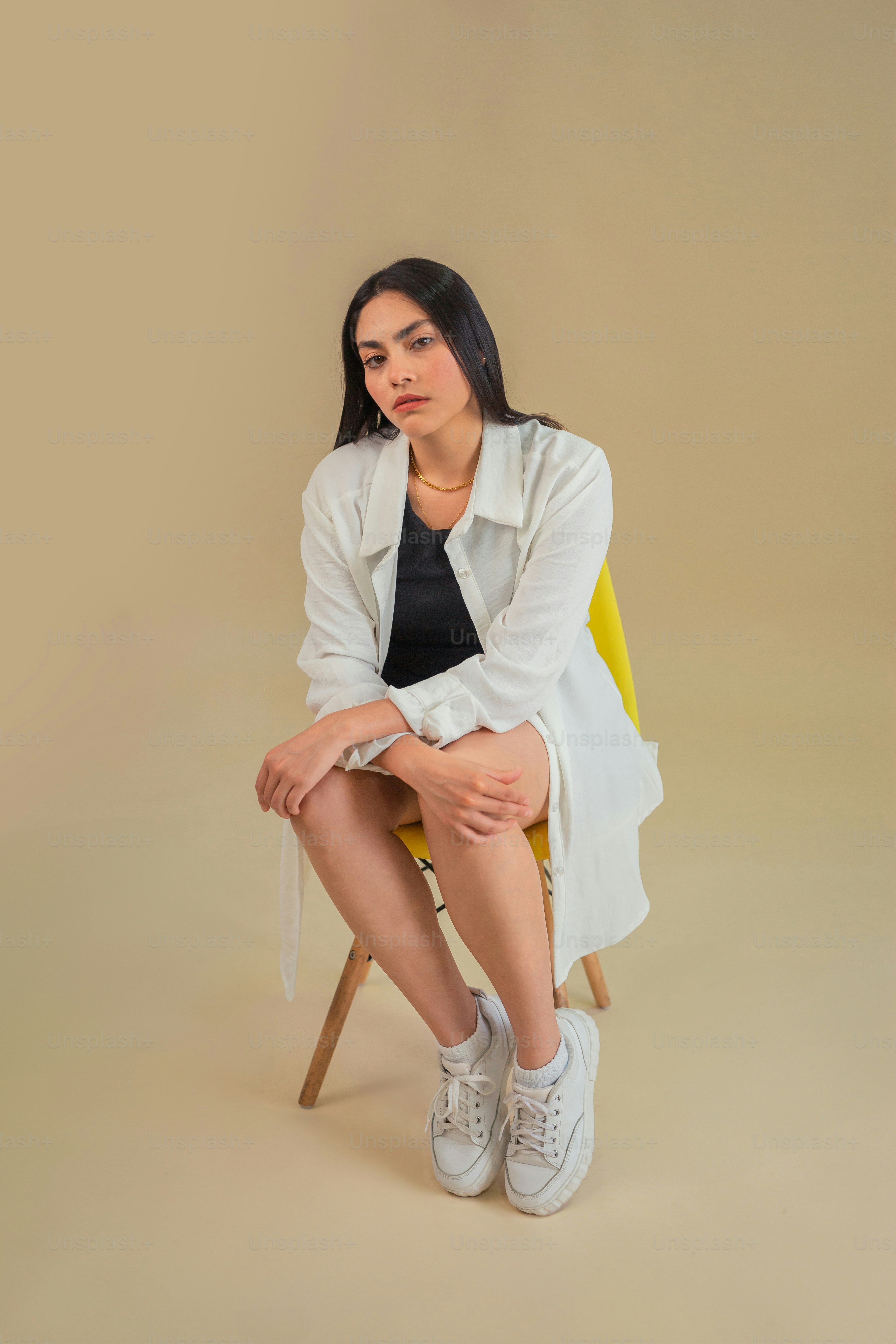 a woman sitting on a chair with her legs crossed