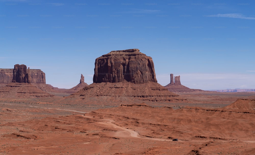 a large rock formation in the middle of a desert