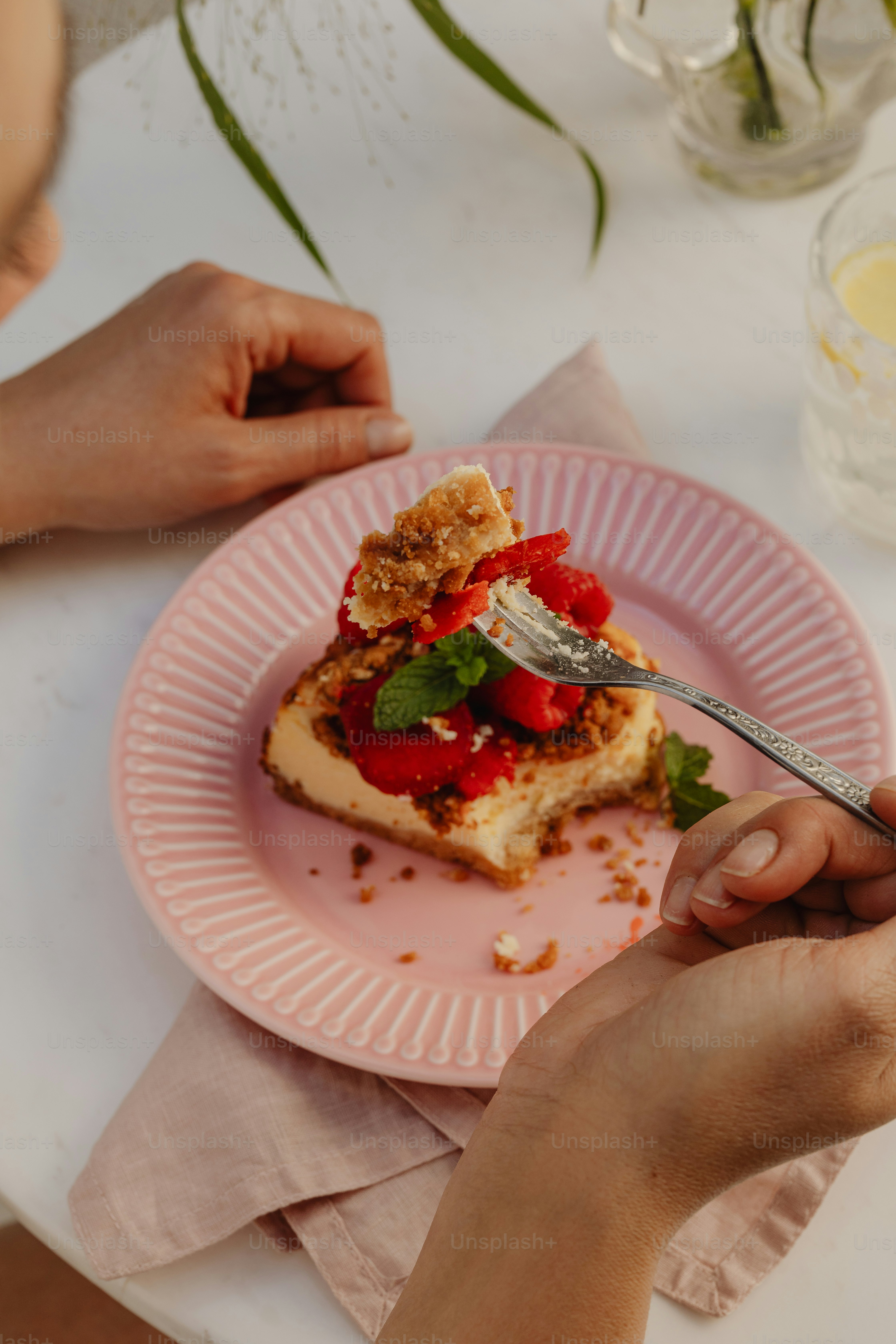un piatto rosa sormontato da cibo e una forchetta
