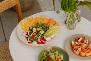 a white table topped with plates of food