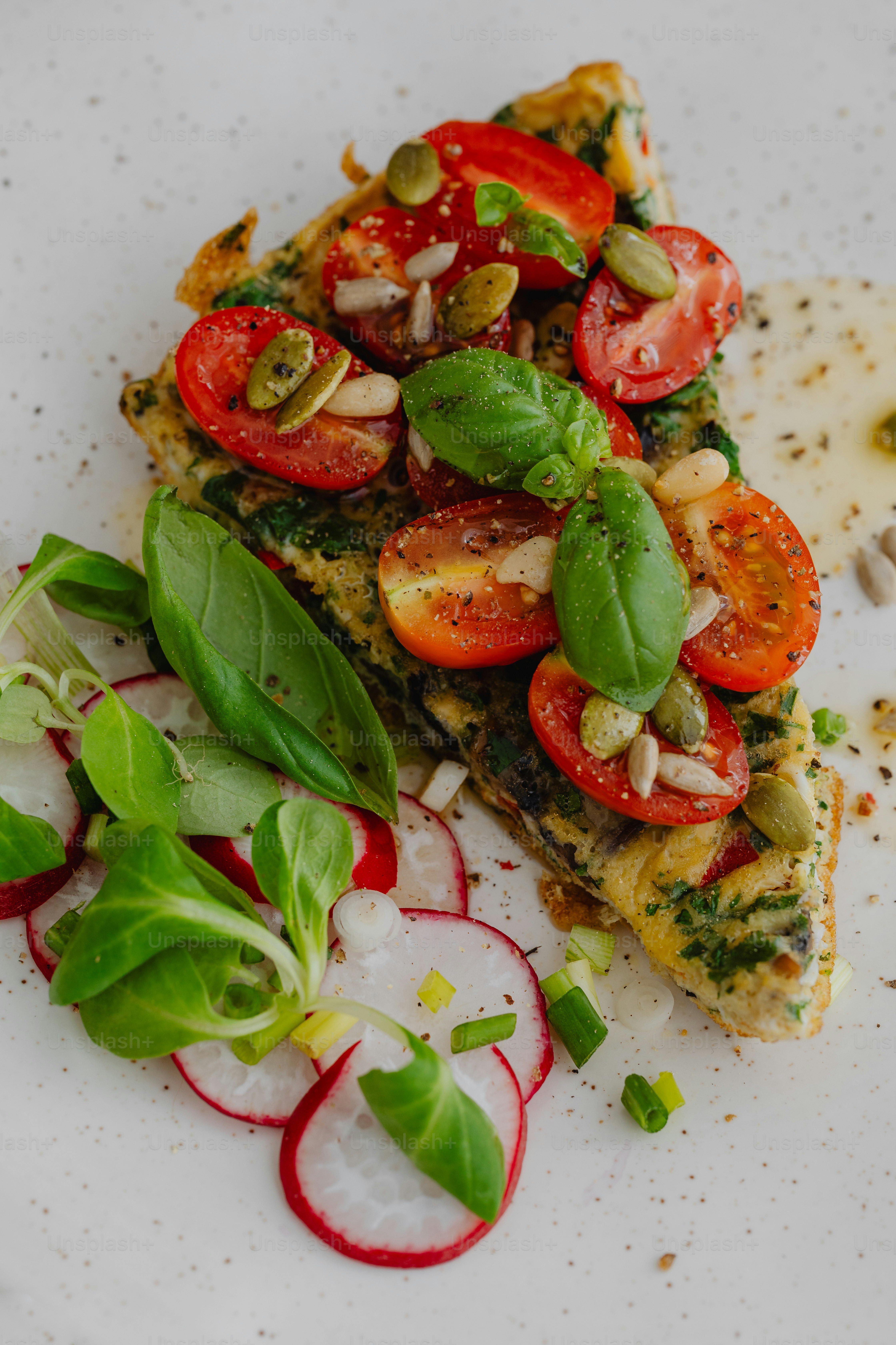 a white plate topped with a slice of pizza covered in veggies