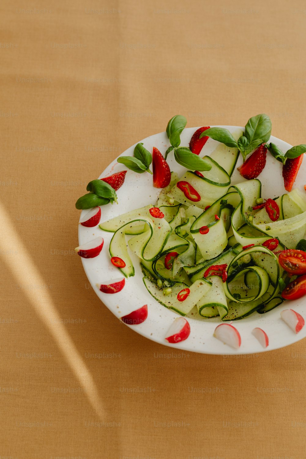 a white plate topped with cucumbers and peppers