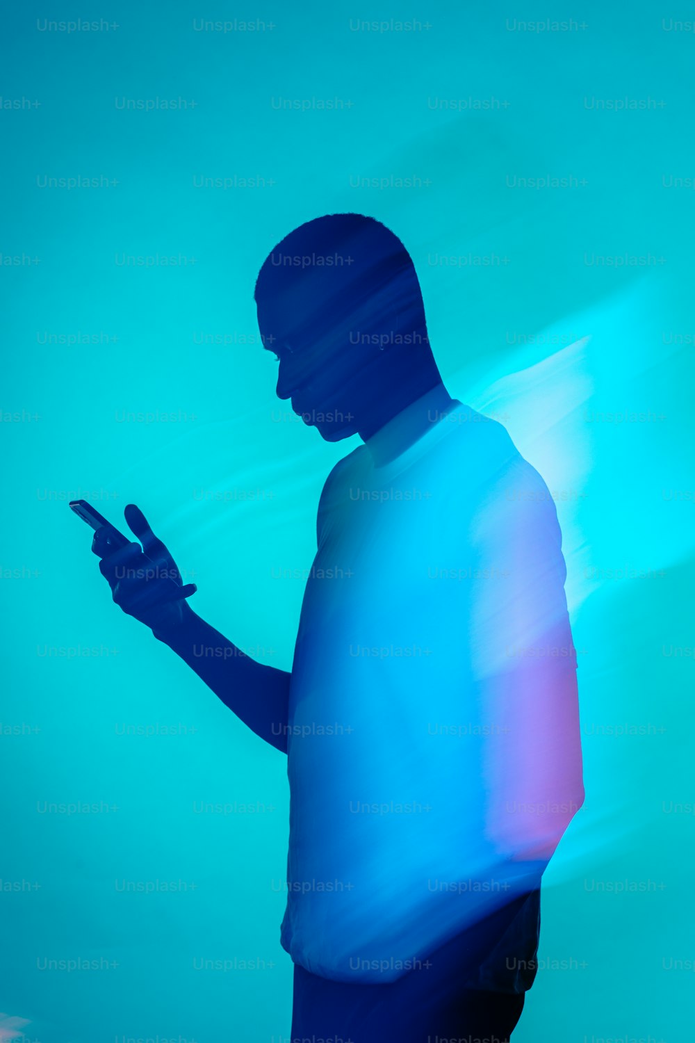 a silhouette of a man holding a cell phone