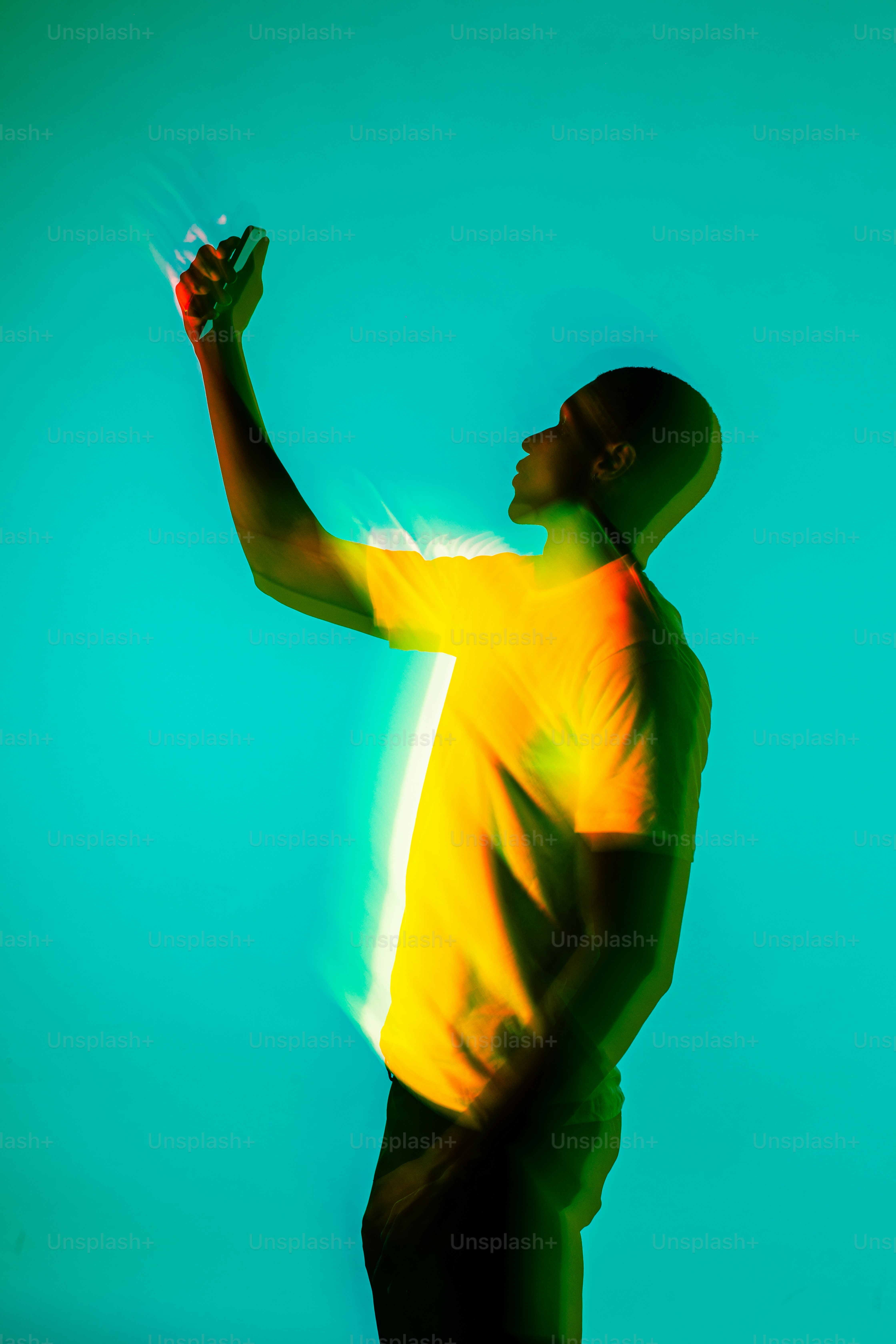 a man in a yellow shirt is holding a frisbee