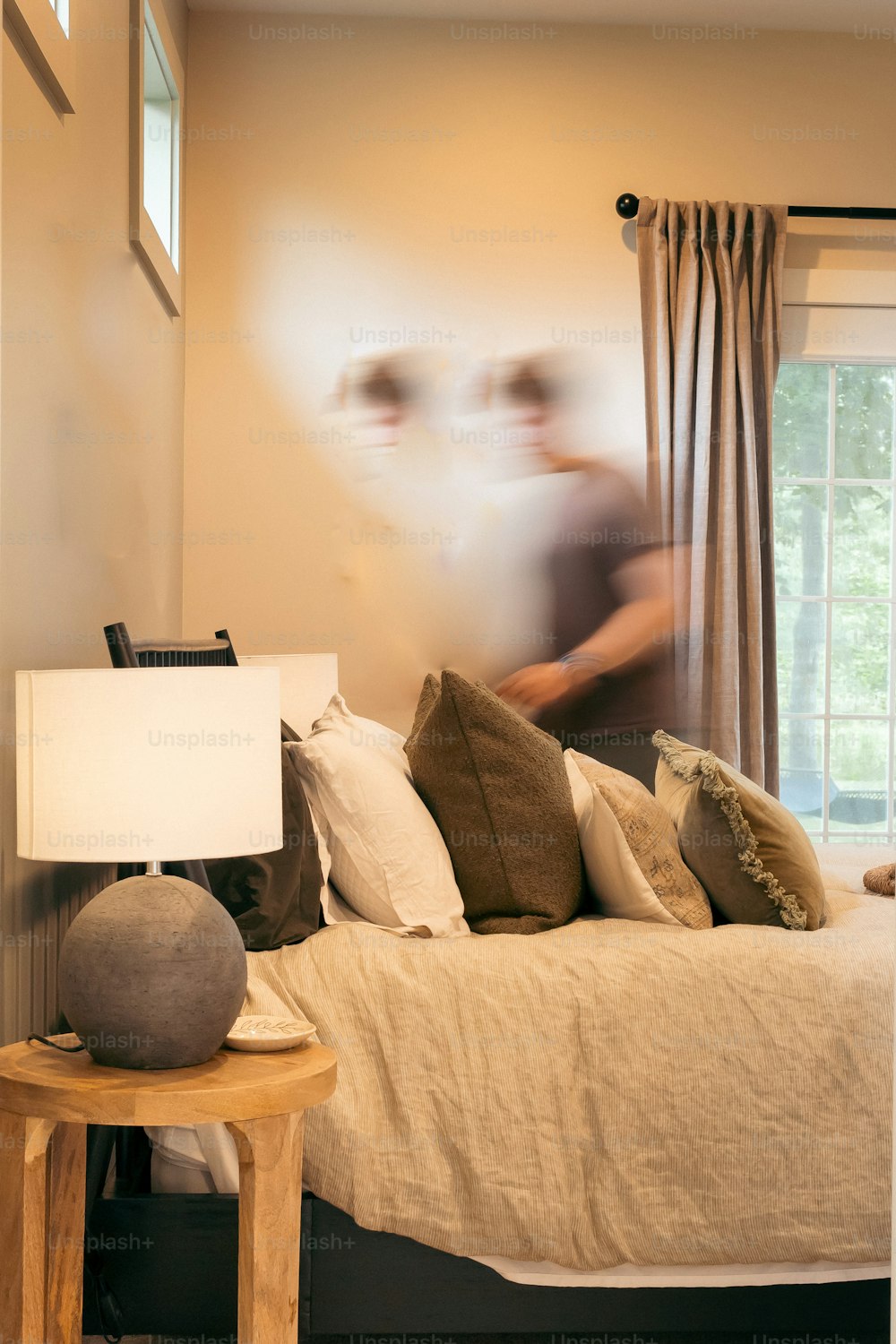 a blurry image of a person in a bedroom