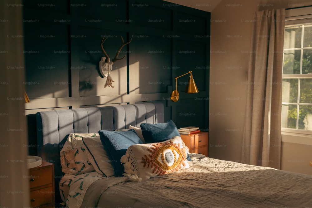 a bed in a bedroom with a deer head on the wall