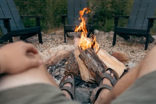 a person sitting in front of a fire pit