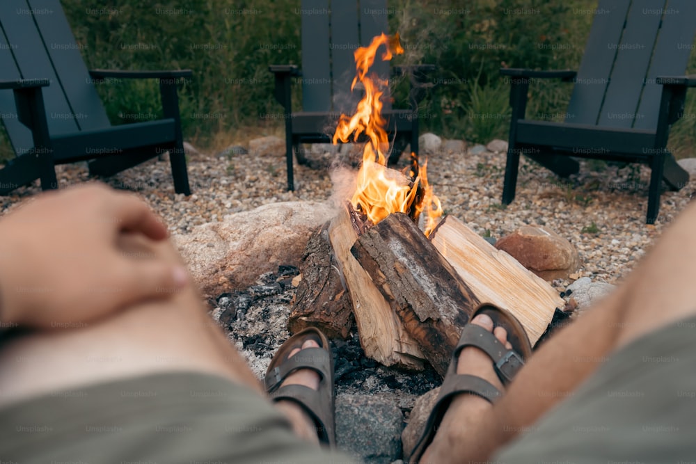 a person sitting in front of a fire pit