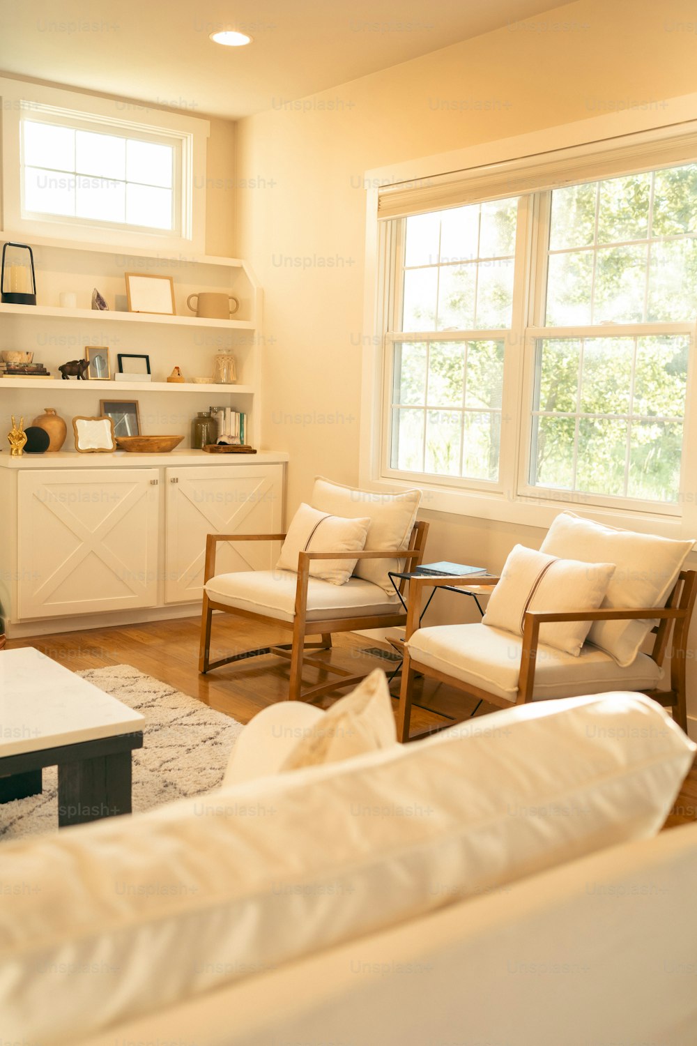 a living room filled with furniture and a large window