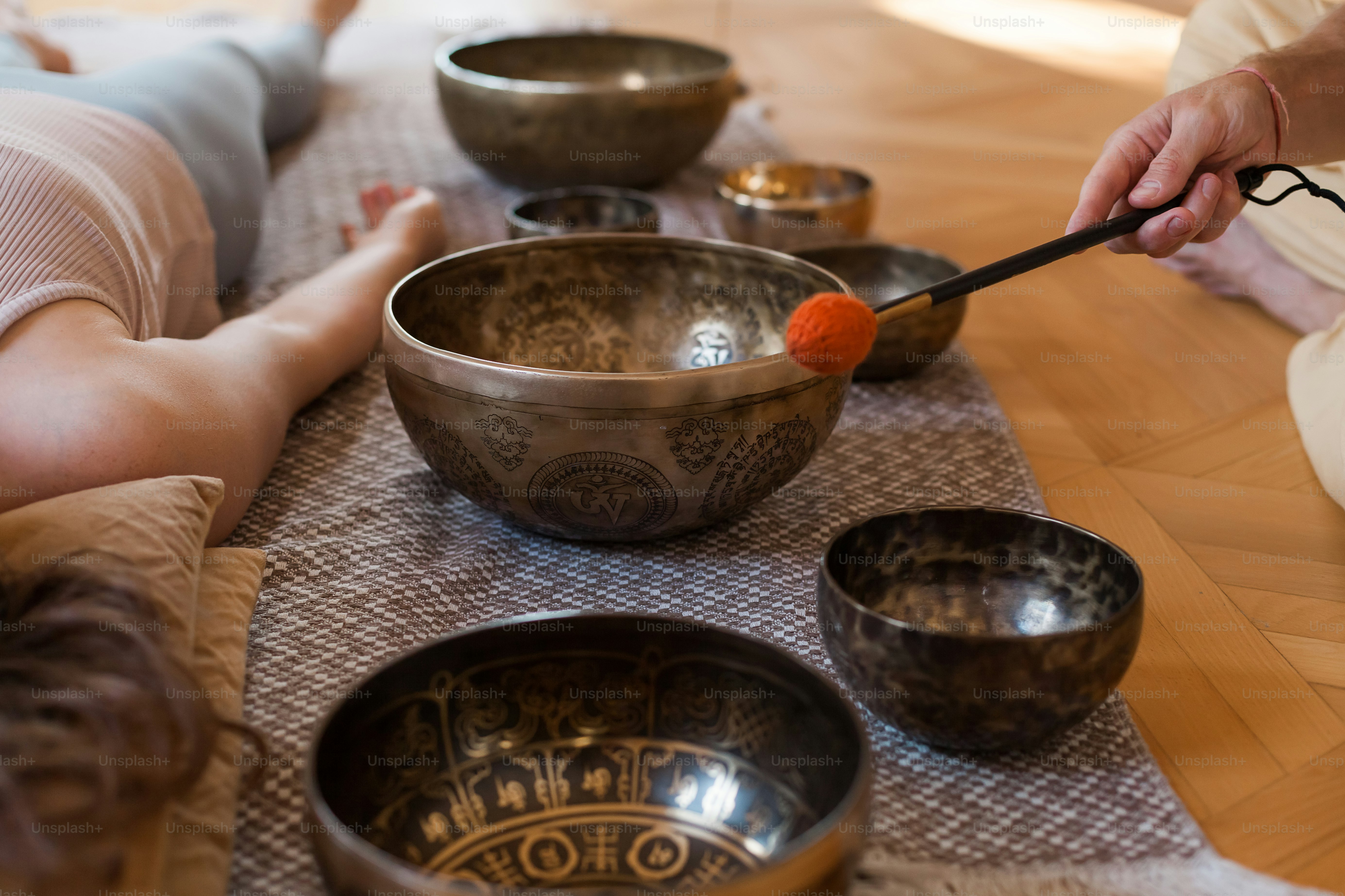 a person sitting on the floor with bowls and a spoon in front of them
