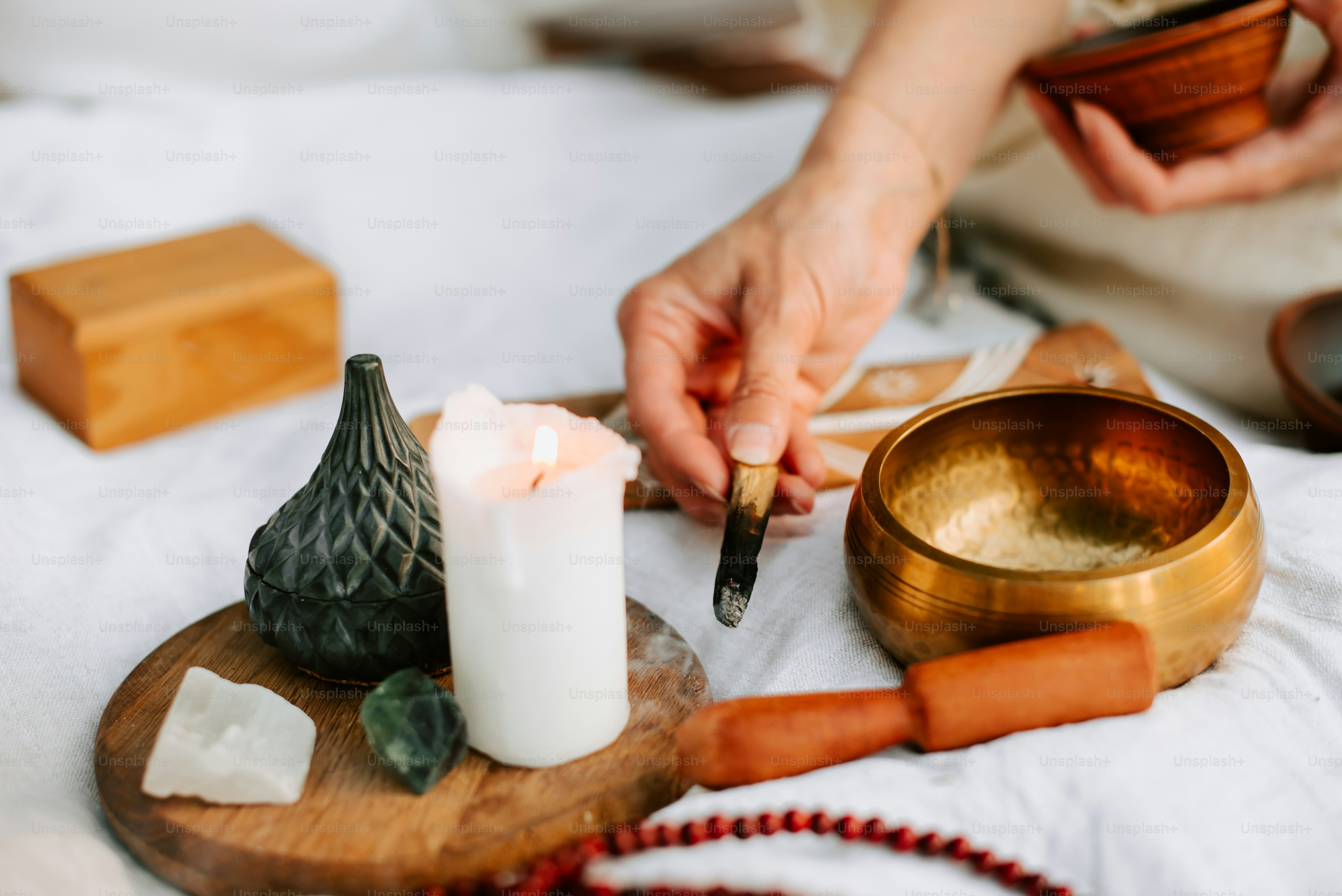 a person is lighting a candle on a tray