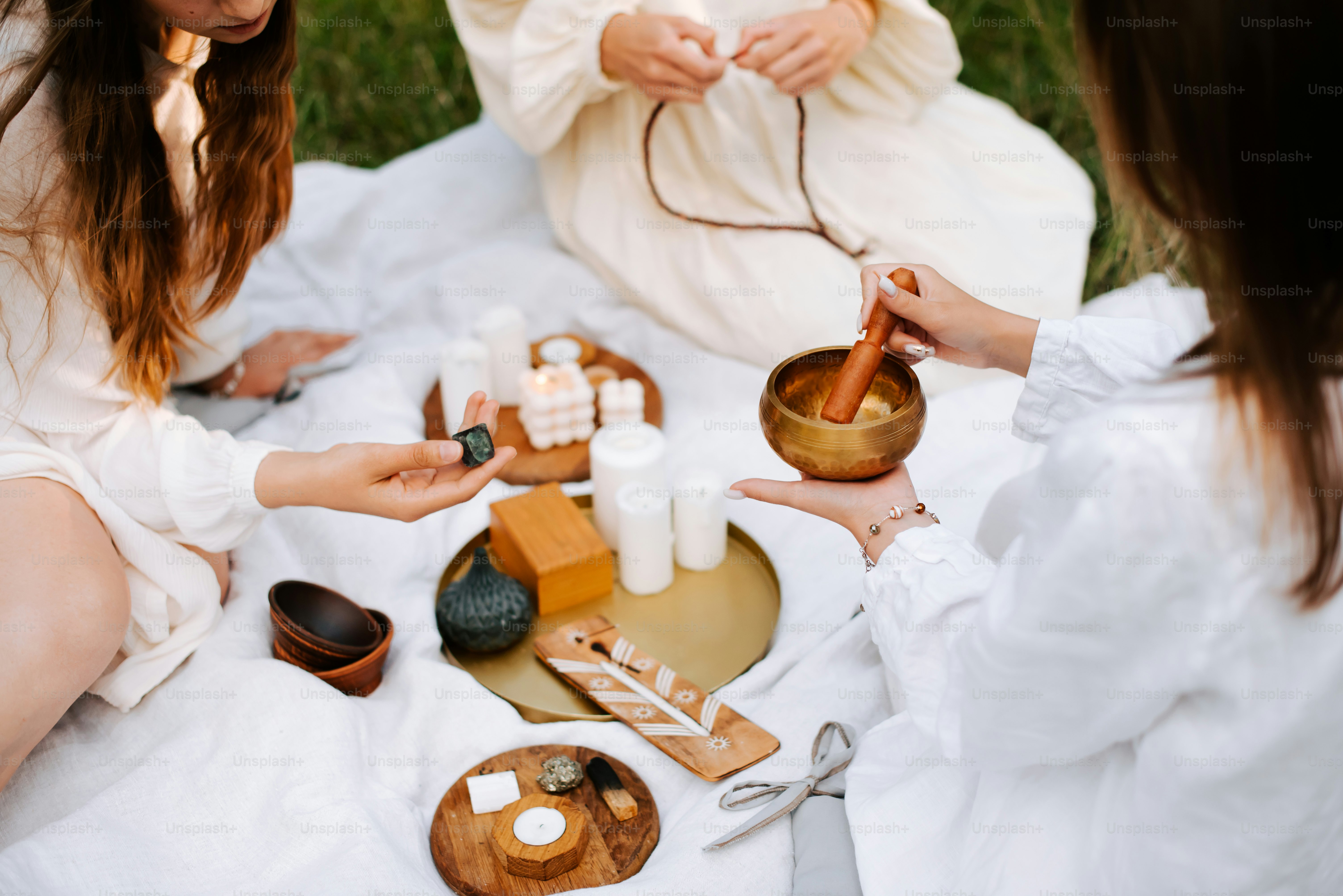 a group of women sitting around a table with candles