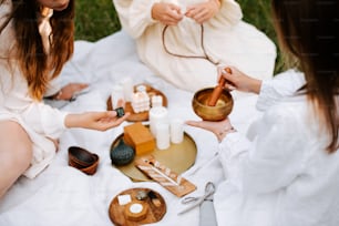 a group of women sitting around a table with candles