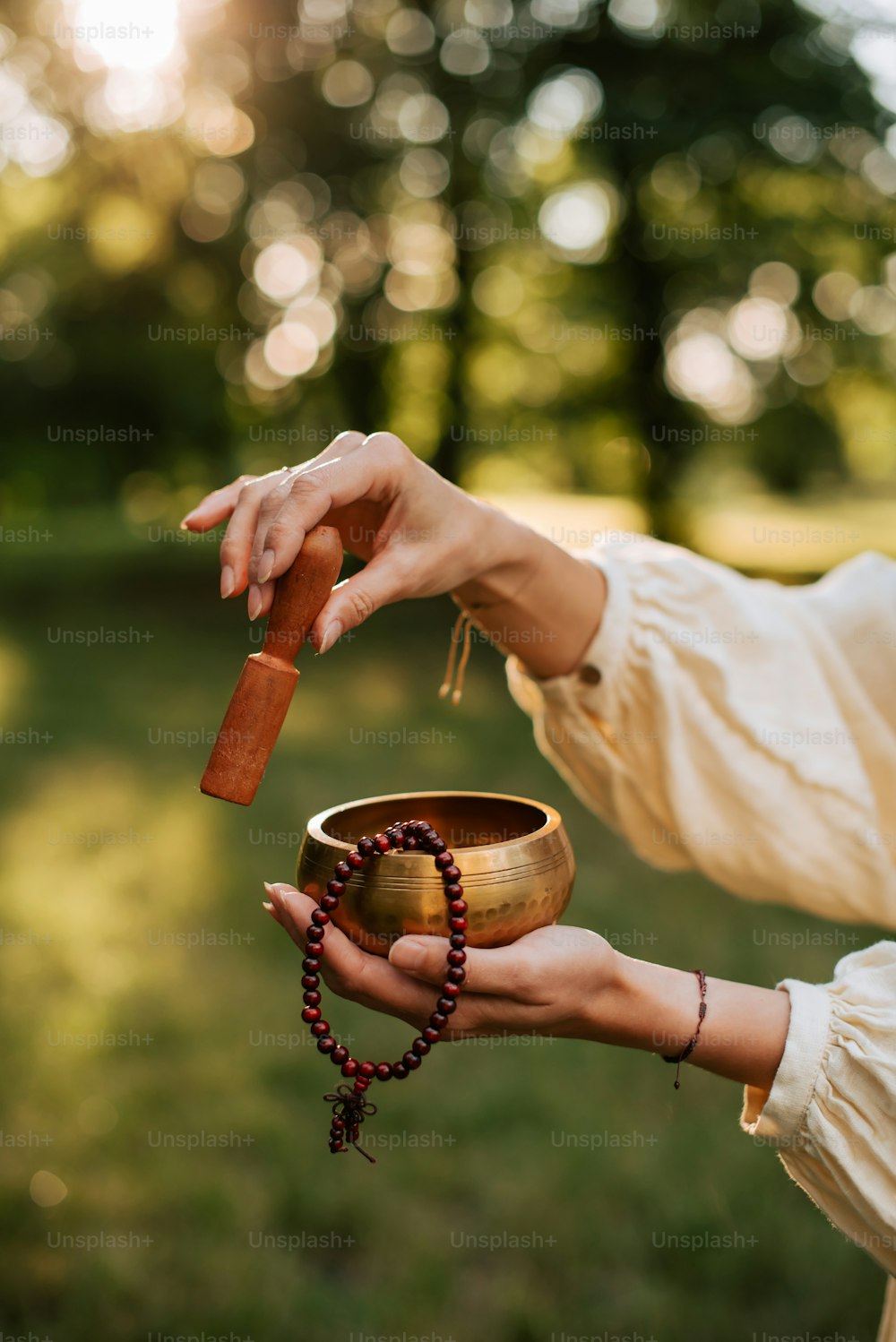a woman holding a wooden chalice in her hand