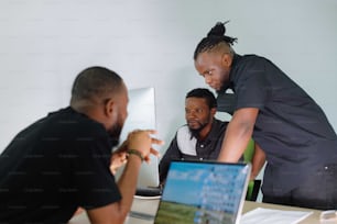 two men looking at a laptop computer screen