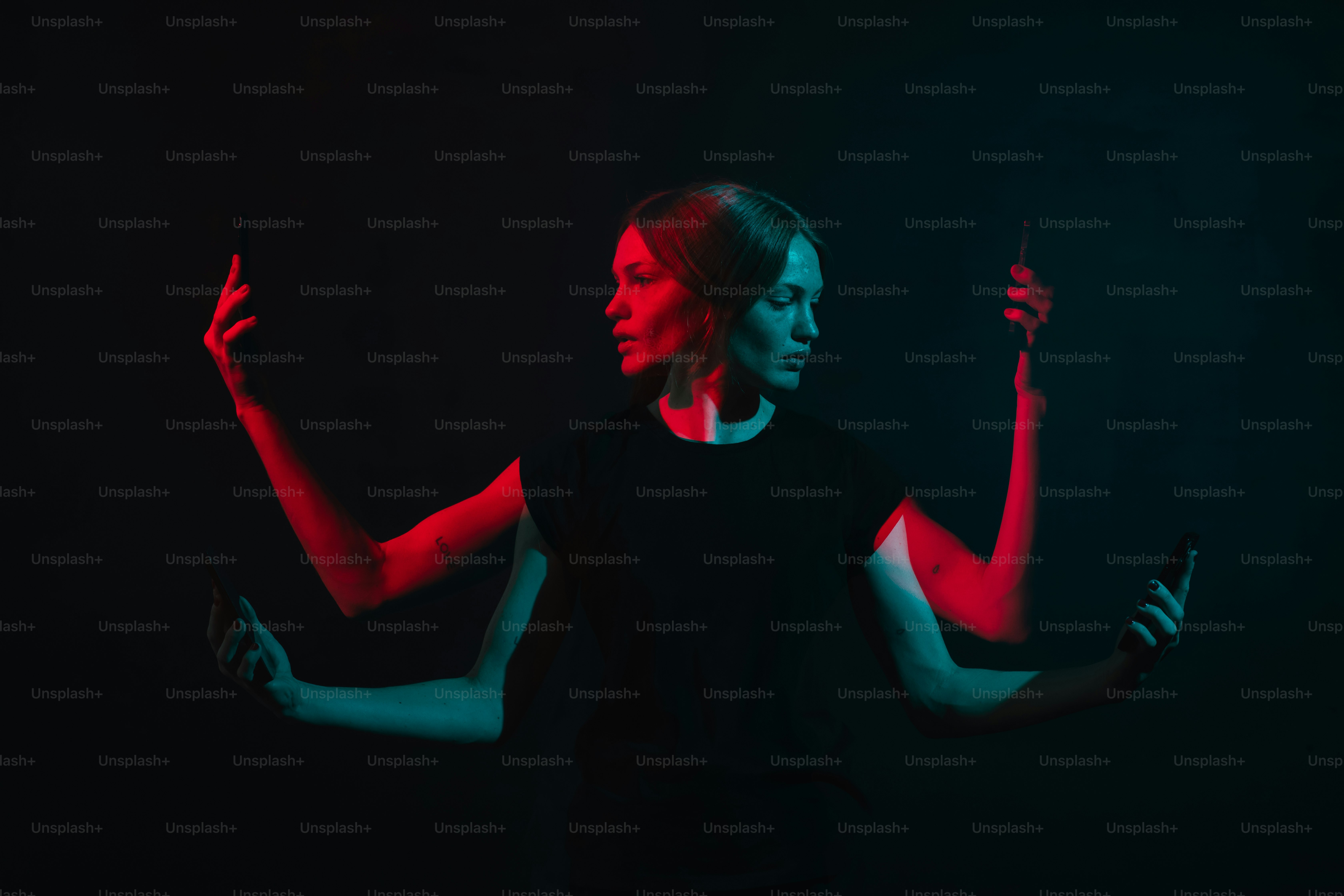 Une femme debout dans le noir tenant un téléphone portable