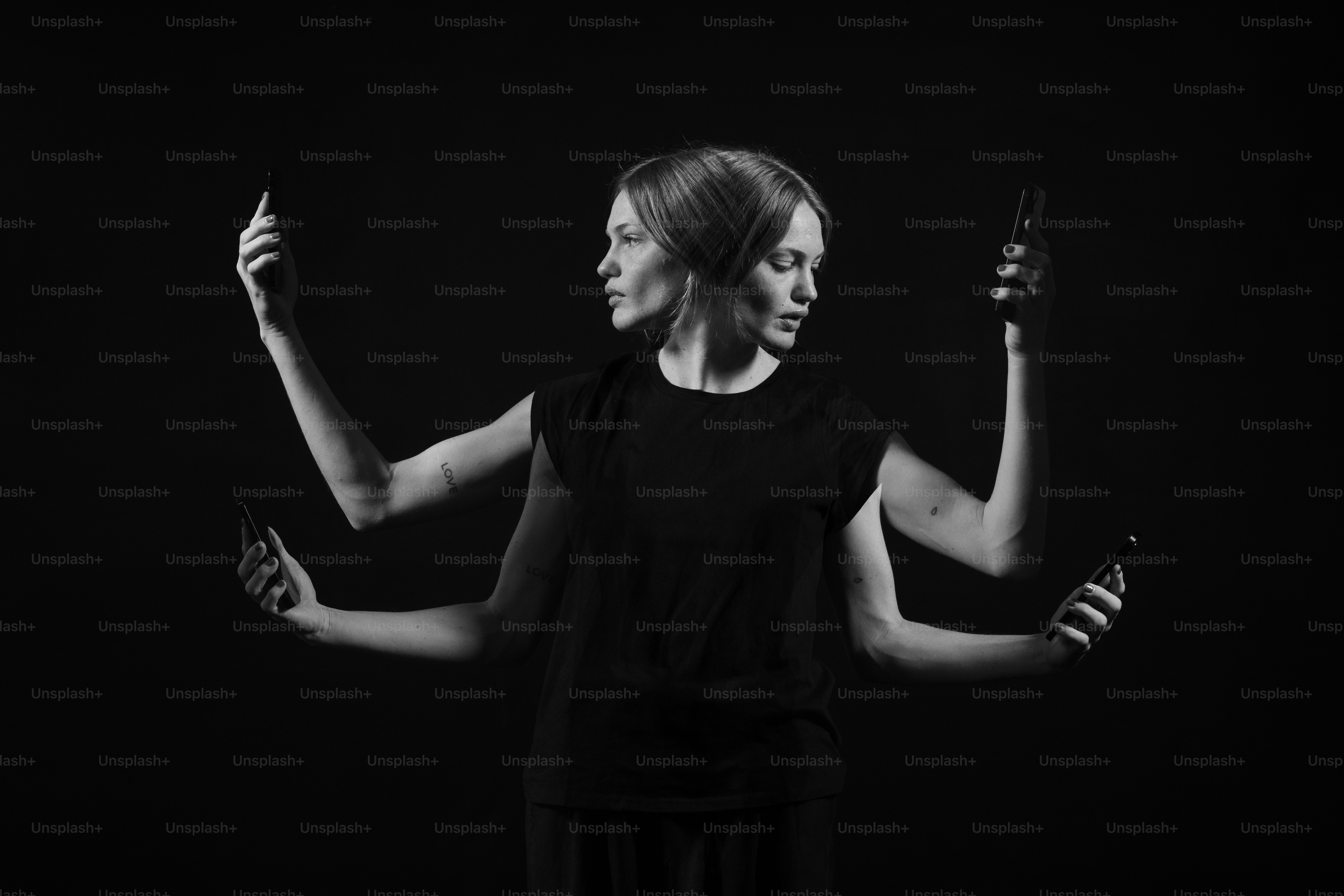 a black and white photo of a woman holding a cell phone