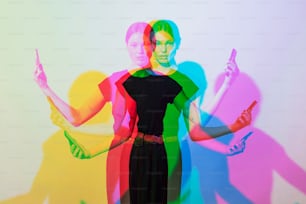 a woman standing in front of a rainbow colored wall