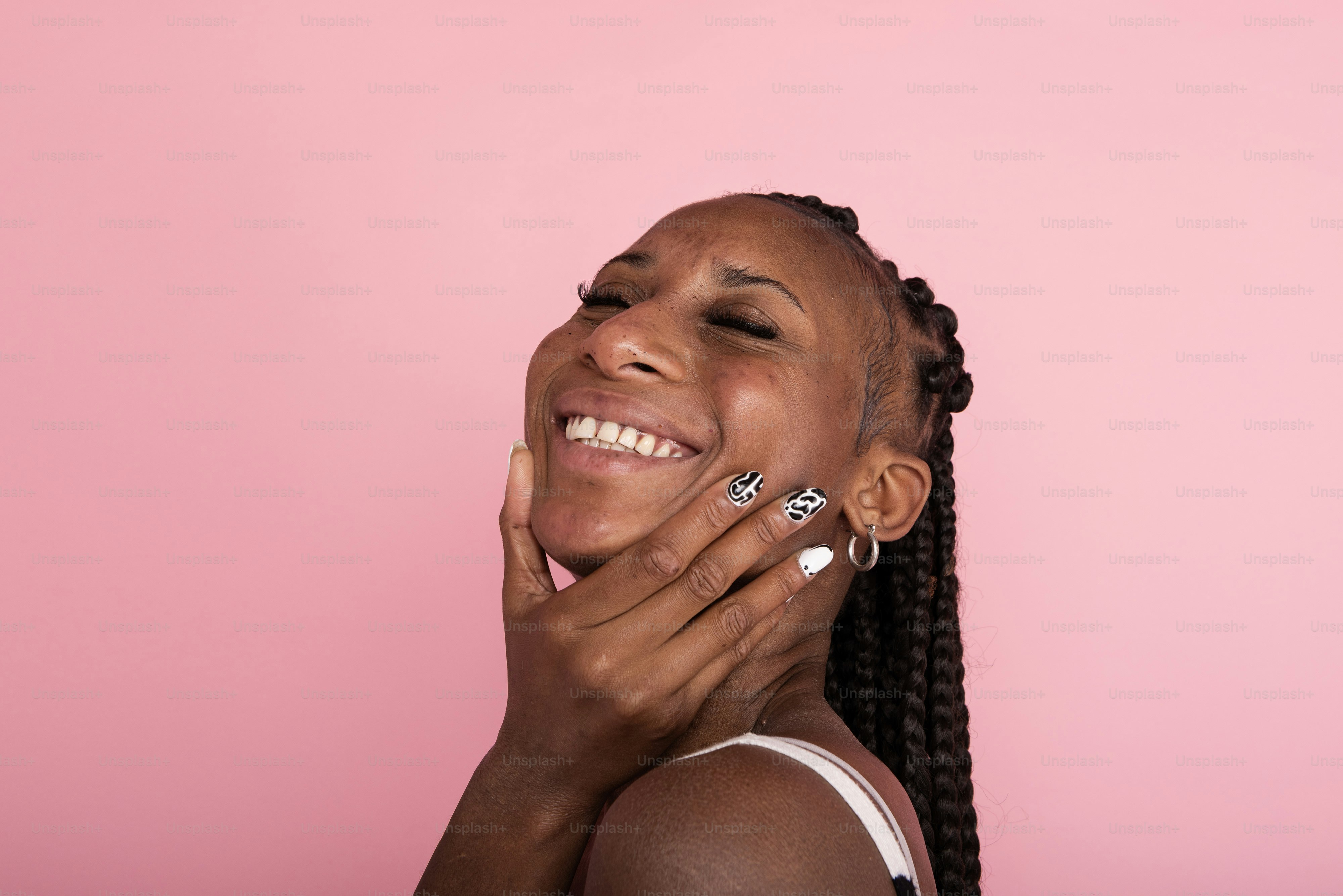 a woman smiling with her hands on her face