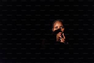 a woman smoking a cigarette in the dark