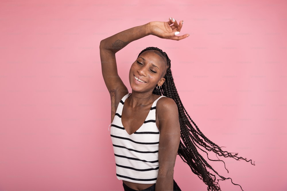 a woman in a striped tank top stretching her arms