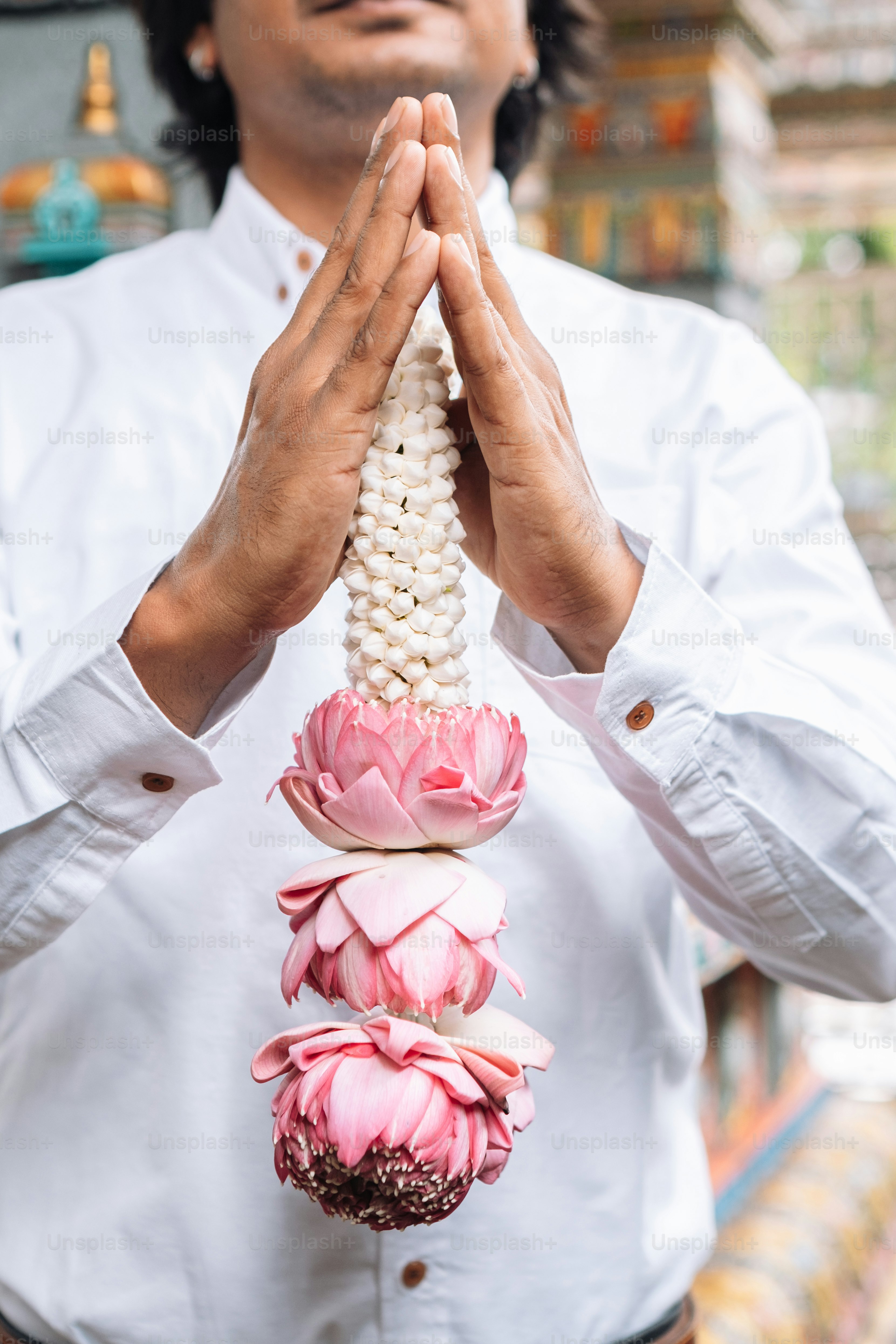 a man in a white shirt holding a string of food