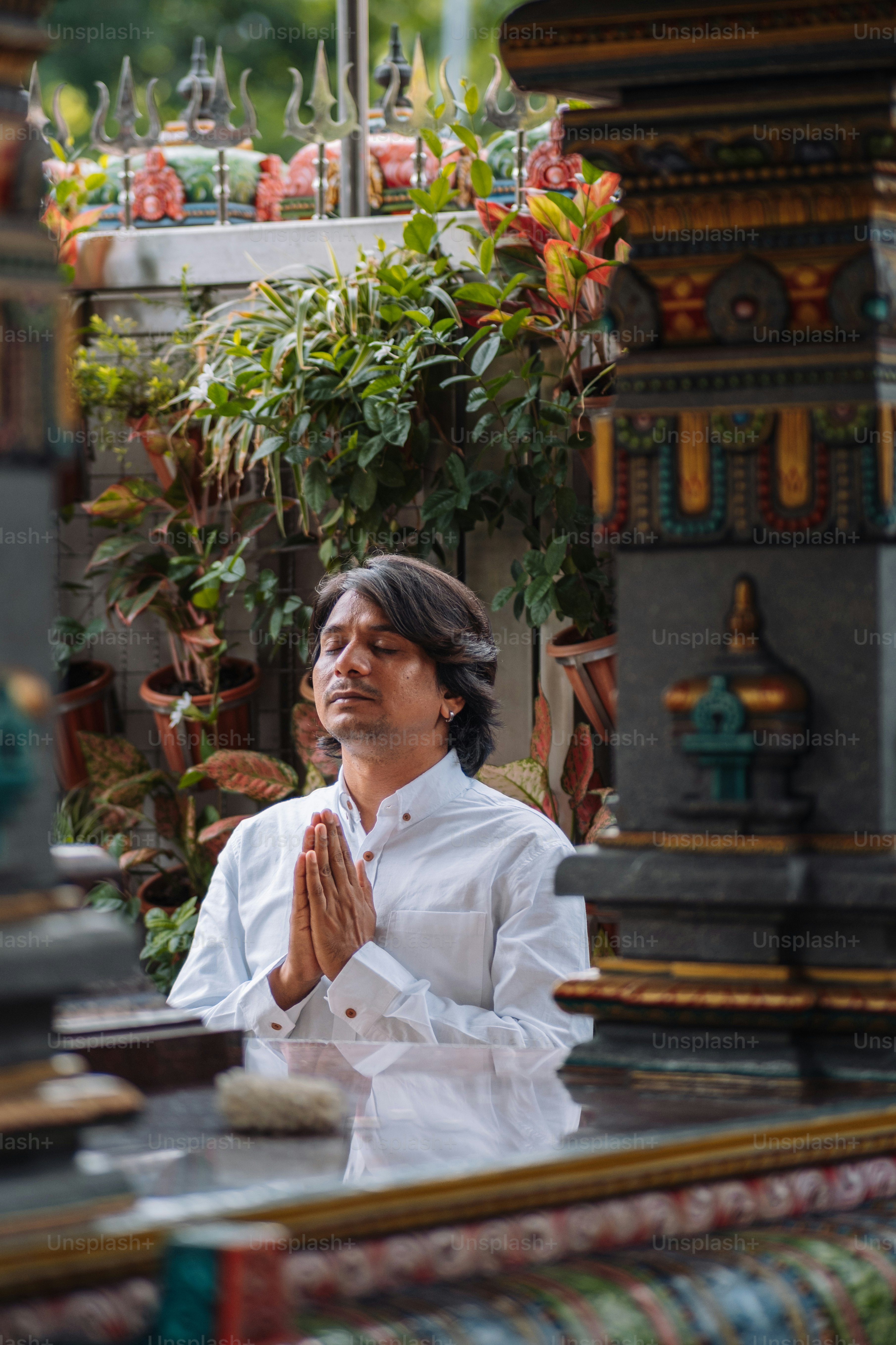 a woman in a white shirt sitting in a room