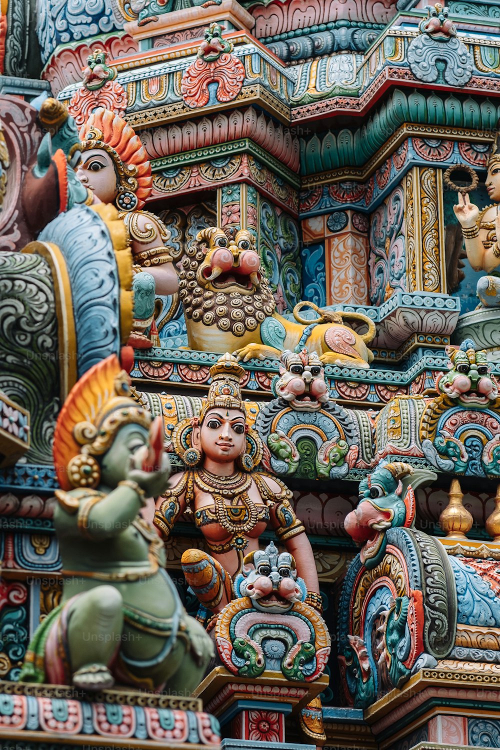 a close up of a colorfully decorated building with statues