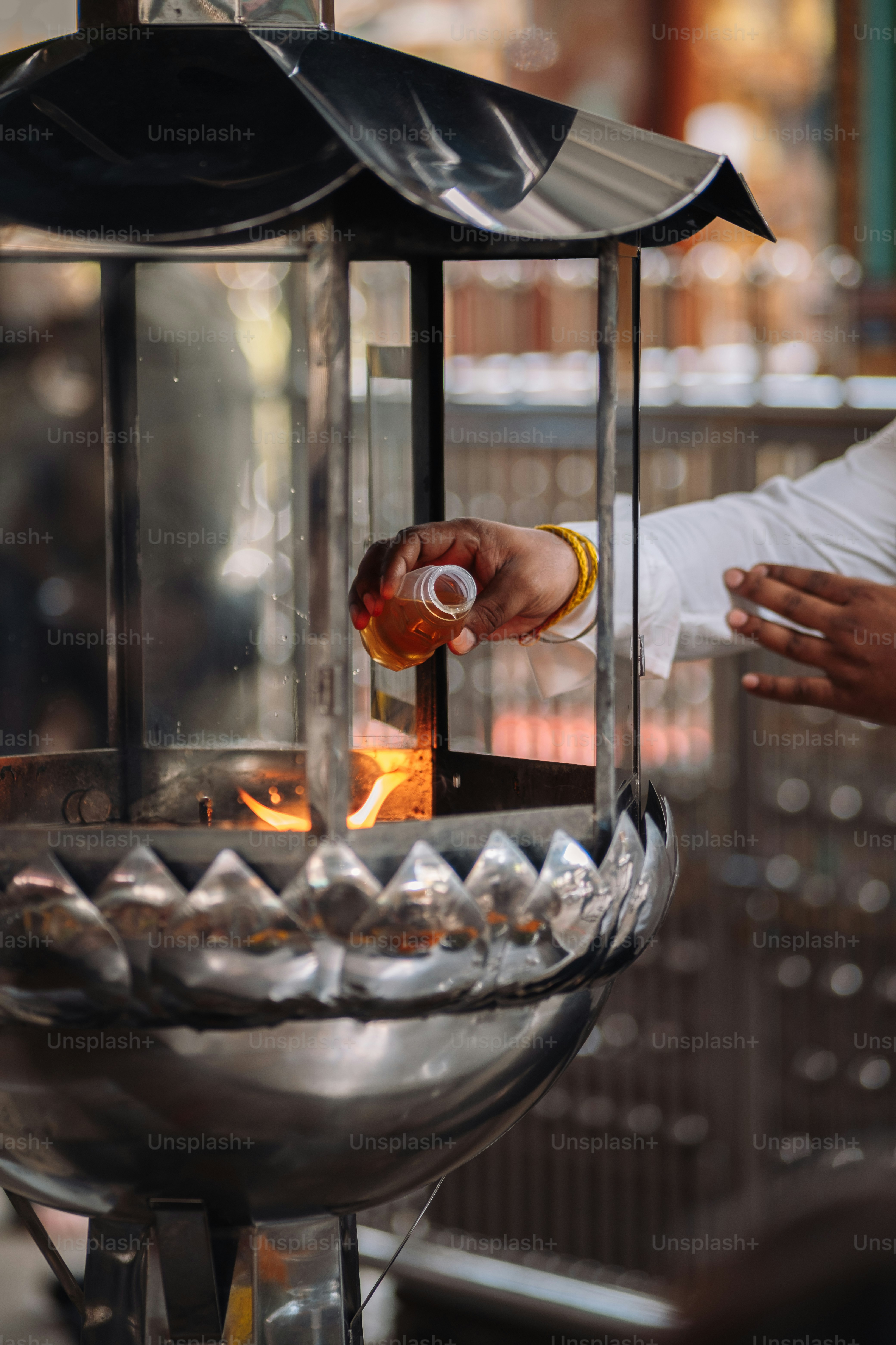 a person pouring something into a glass container