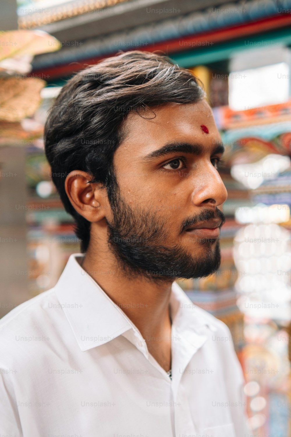 a man with a beard and a white shirt