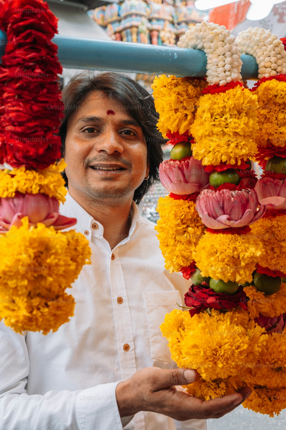 a man holding a bunch of flowers in his hands