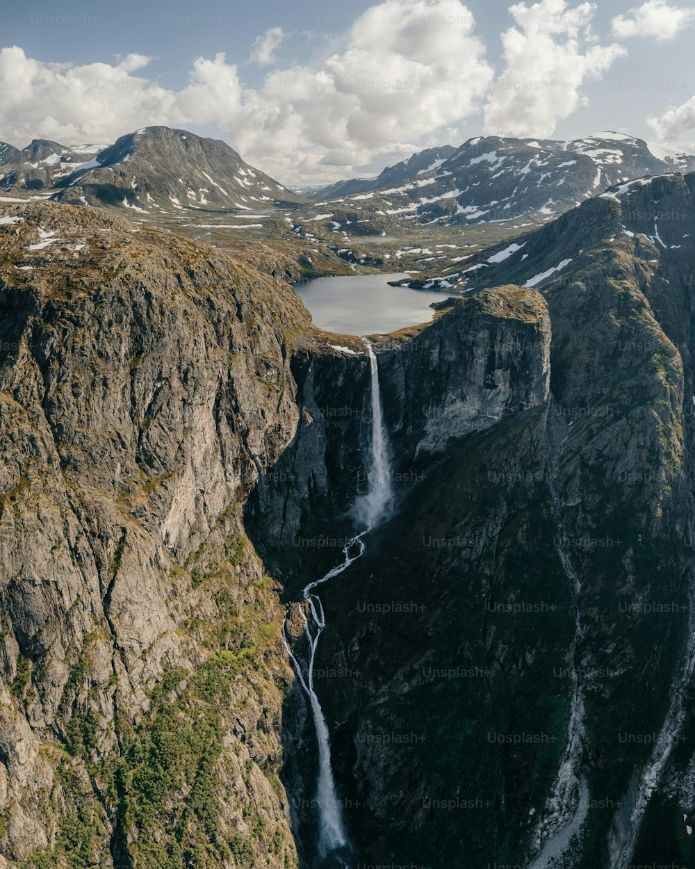 a waterfall in the middle of a mountain range