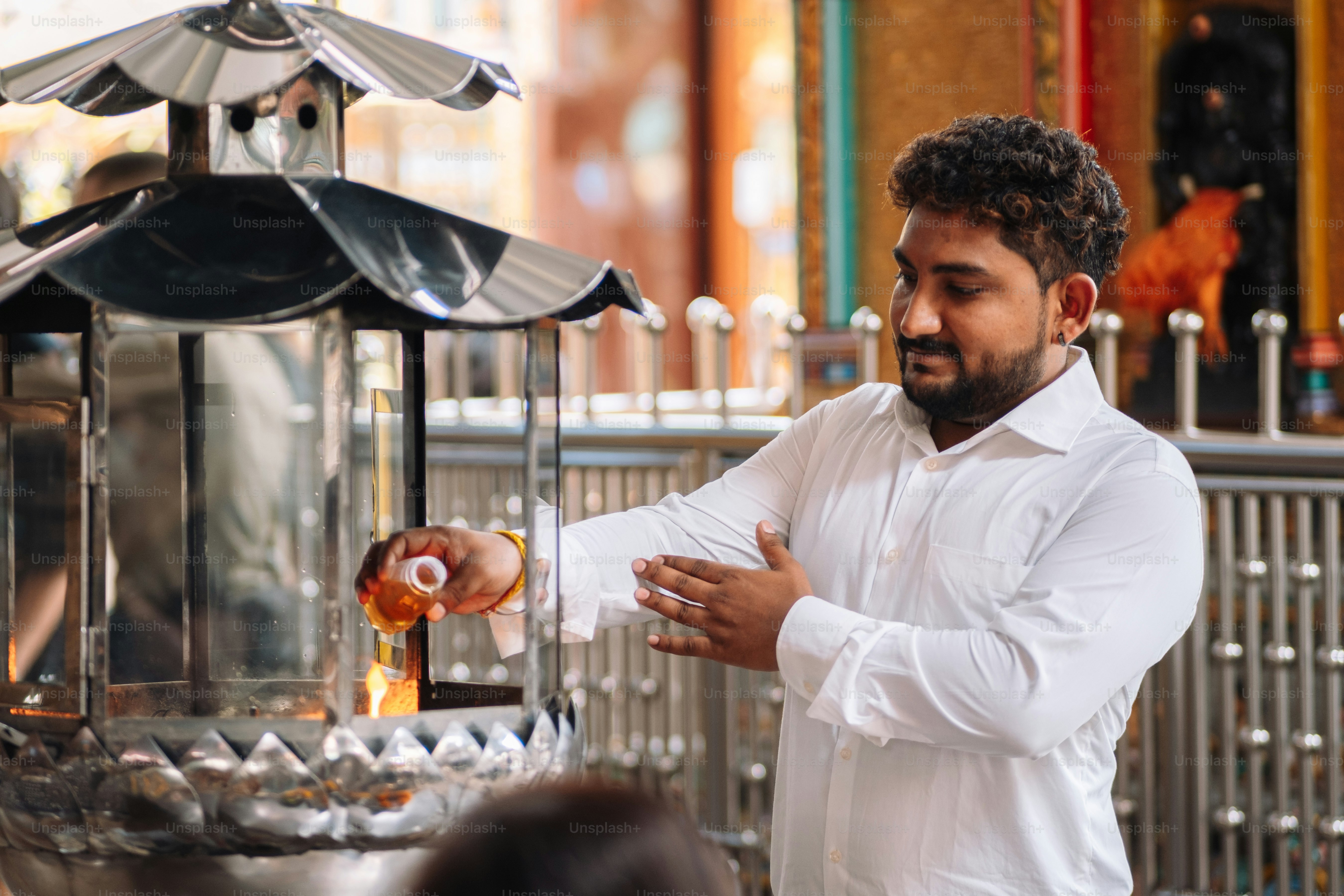 a man standing in front of a machine pouring something