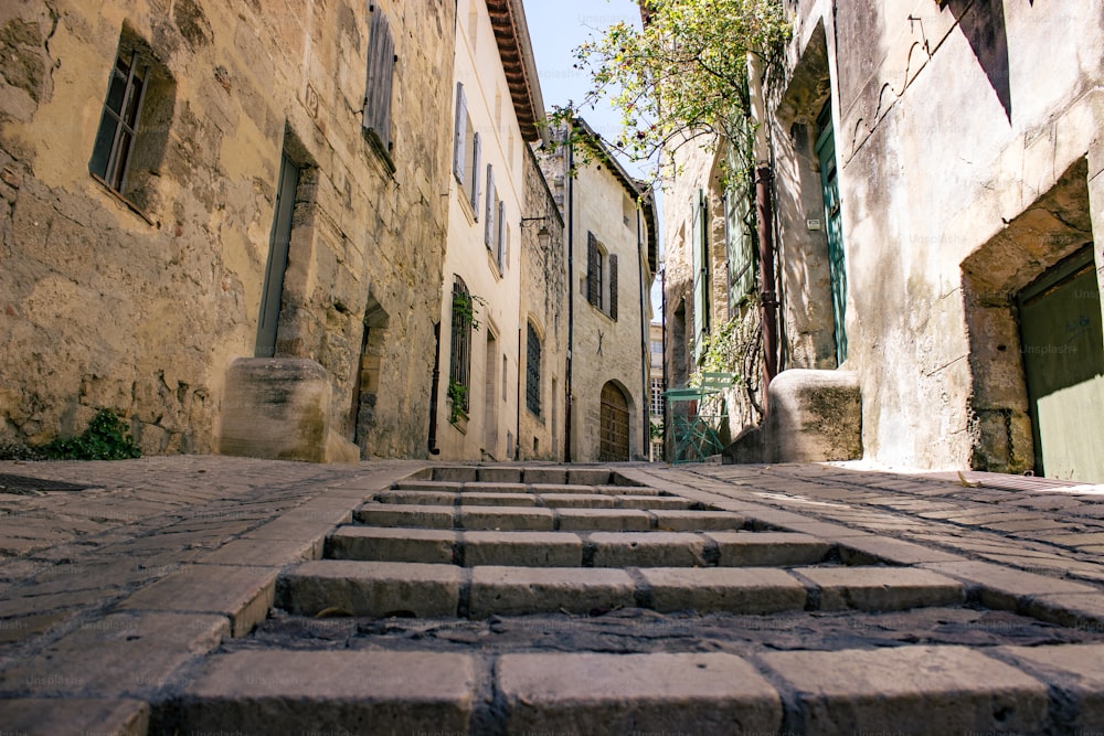 a cobblestone street with steps leading up to a building